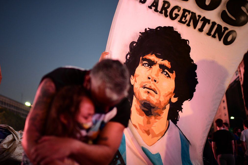 Un padre y su hija lloran la muerte del futbolista Diego Maradona