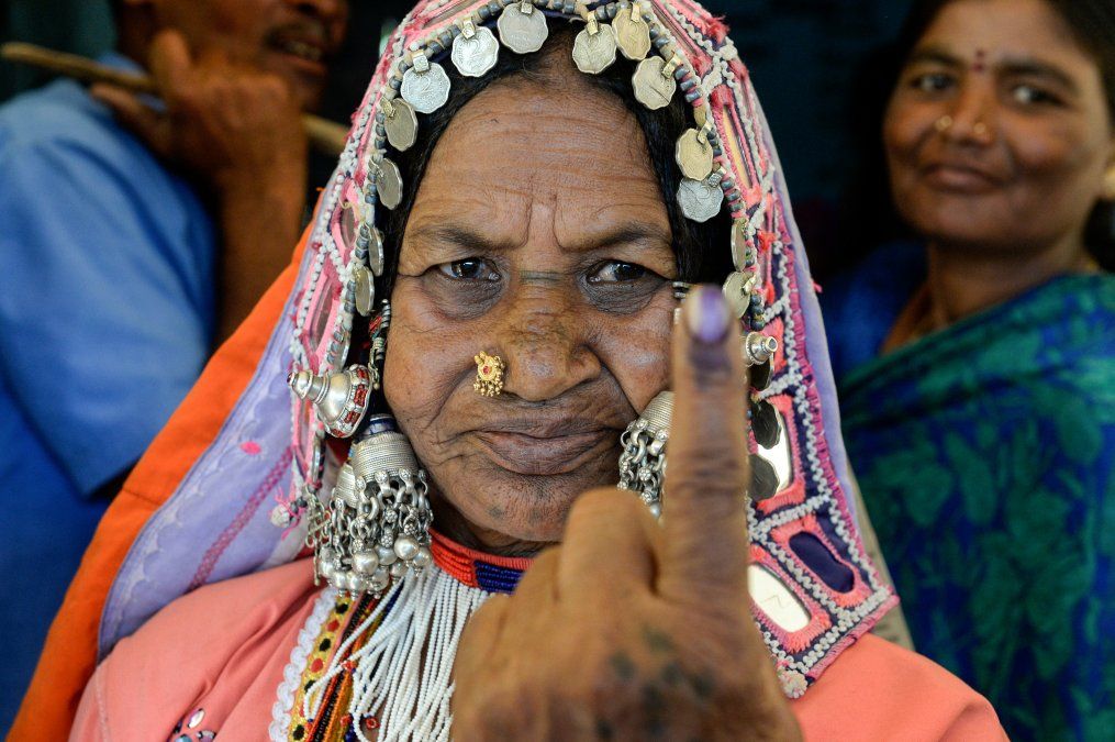 Una mujer indígena Iambadí muestra su dedo marcado con tinta después de votar durante las elecciones generales de la India