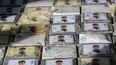Foto: FocoUy. Operación Árabe, 29 de Marzo 2021. Incautación de mas de 600 kg de cocaína con al cara del Chapo Guzmán.